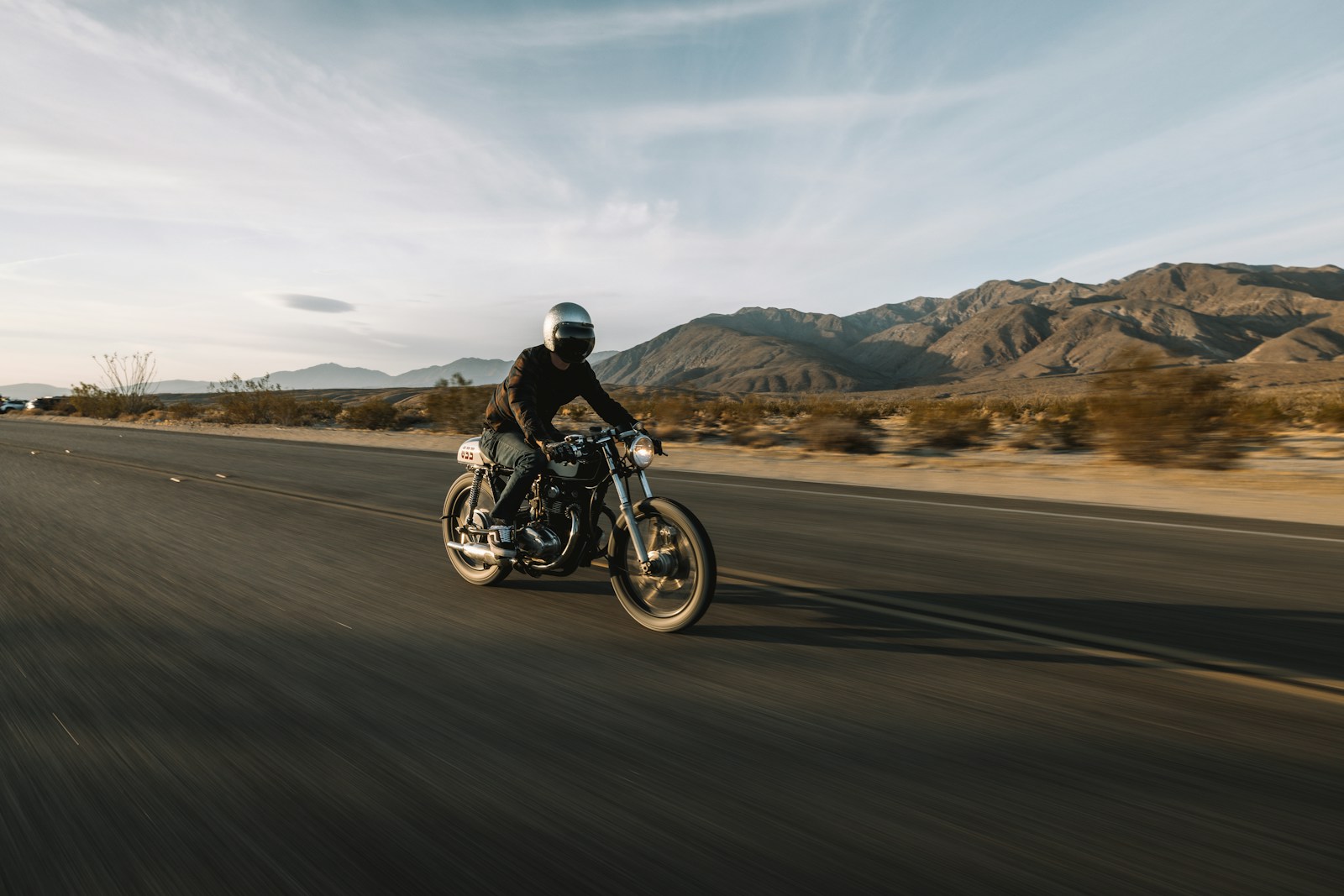 man riding motorcycle on road during daytime